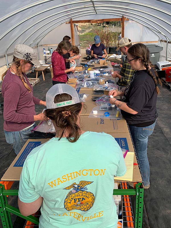 Participants set up irrigation systems for building nurseries back at their own locations.